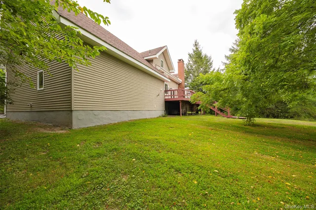a front view of a house with plants and garden