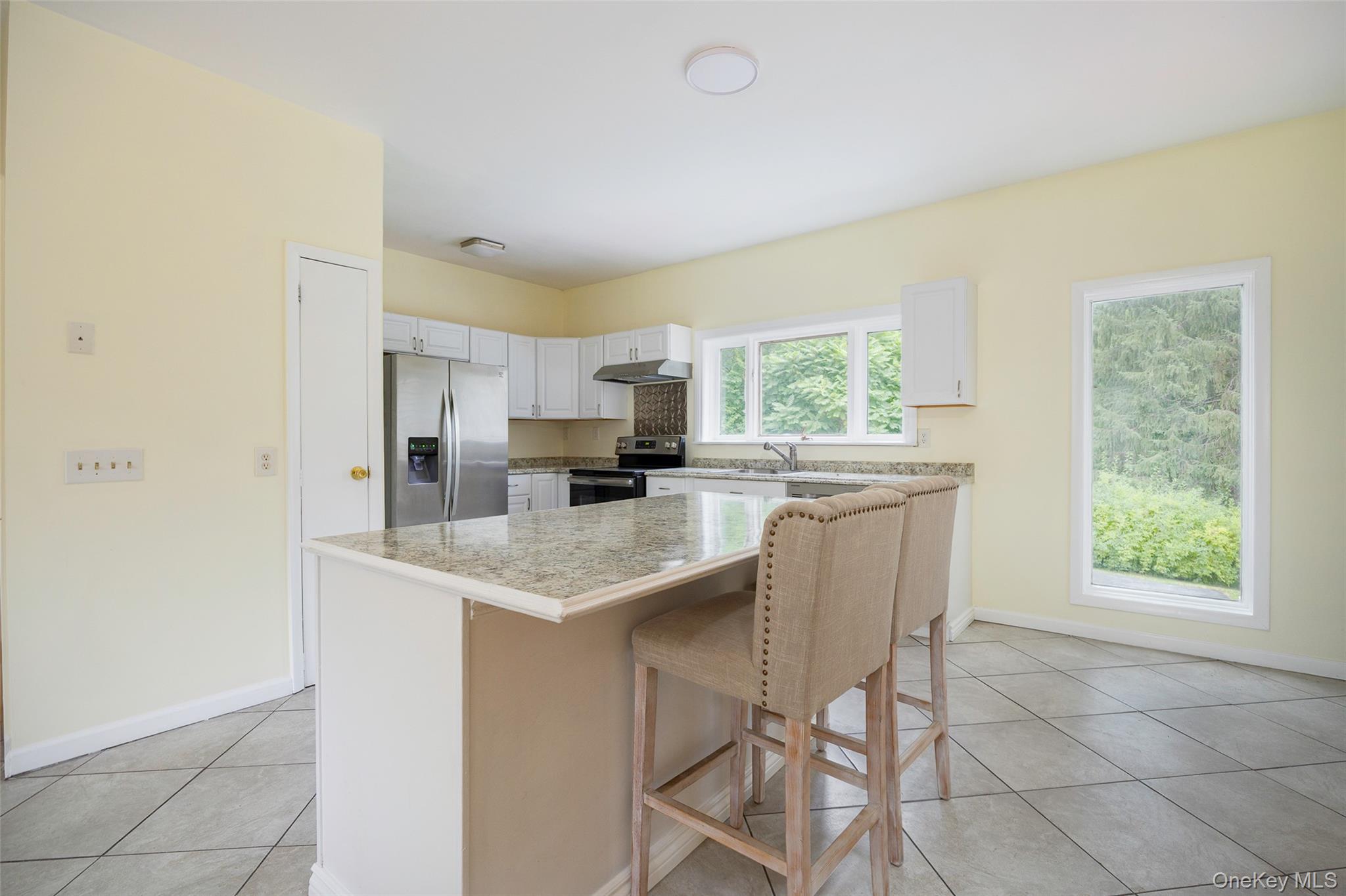 303 Freedom Road Pleasant Valley, NY 12569 - Photo 5 of 40 a kitchen with kitchen island granite countertop white cabinets and stainless steel appliances