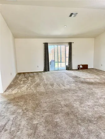 an empty room with windows and a ceiling fan
