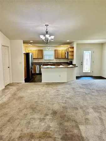 a large kitchen with kitchen island a sink stainless steel appliances and cabinets