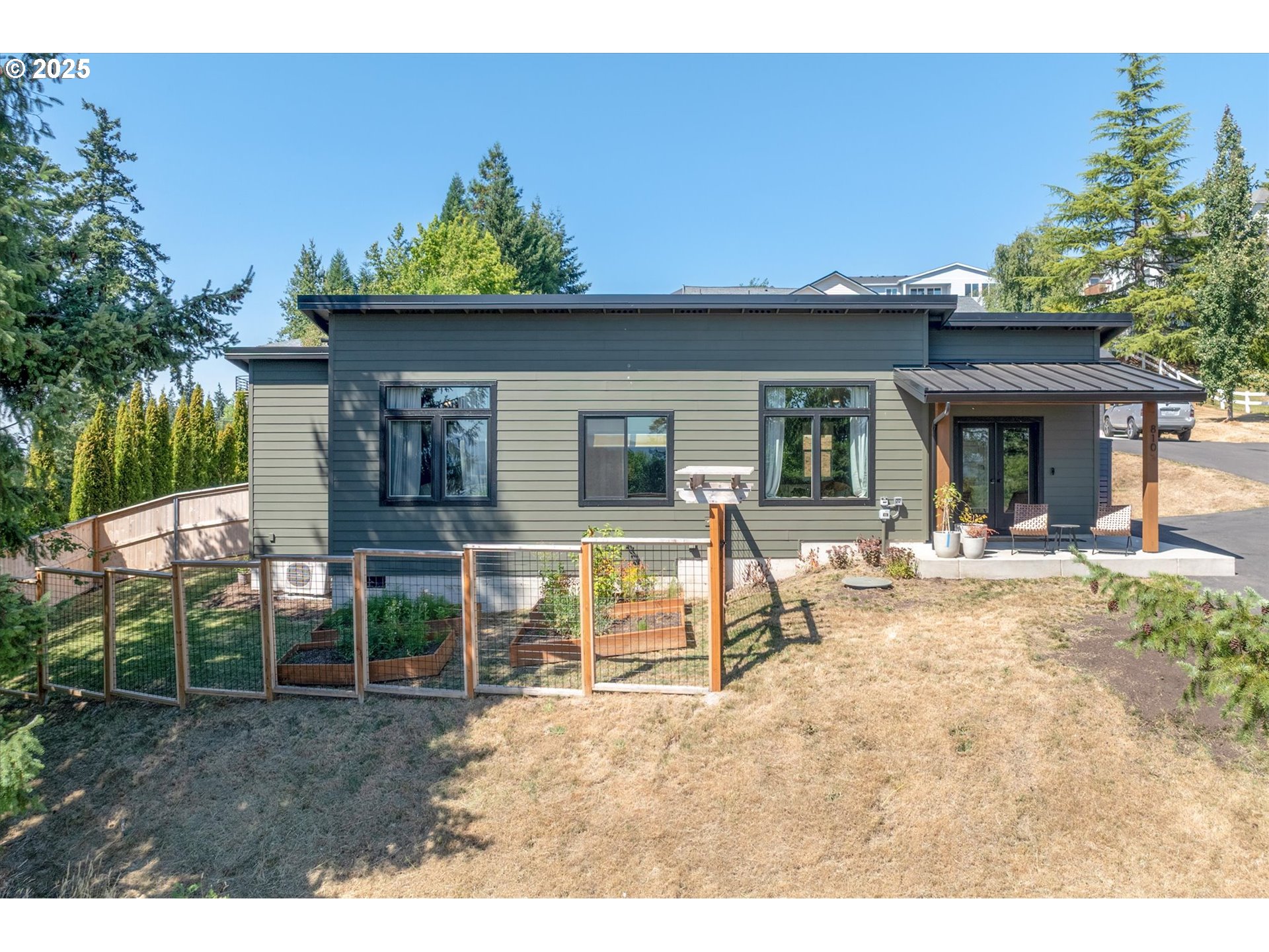 a view of a house with backyard porch and sitting area