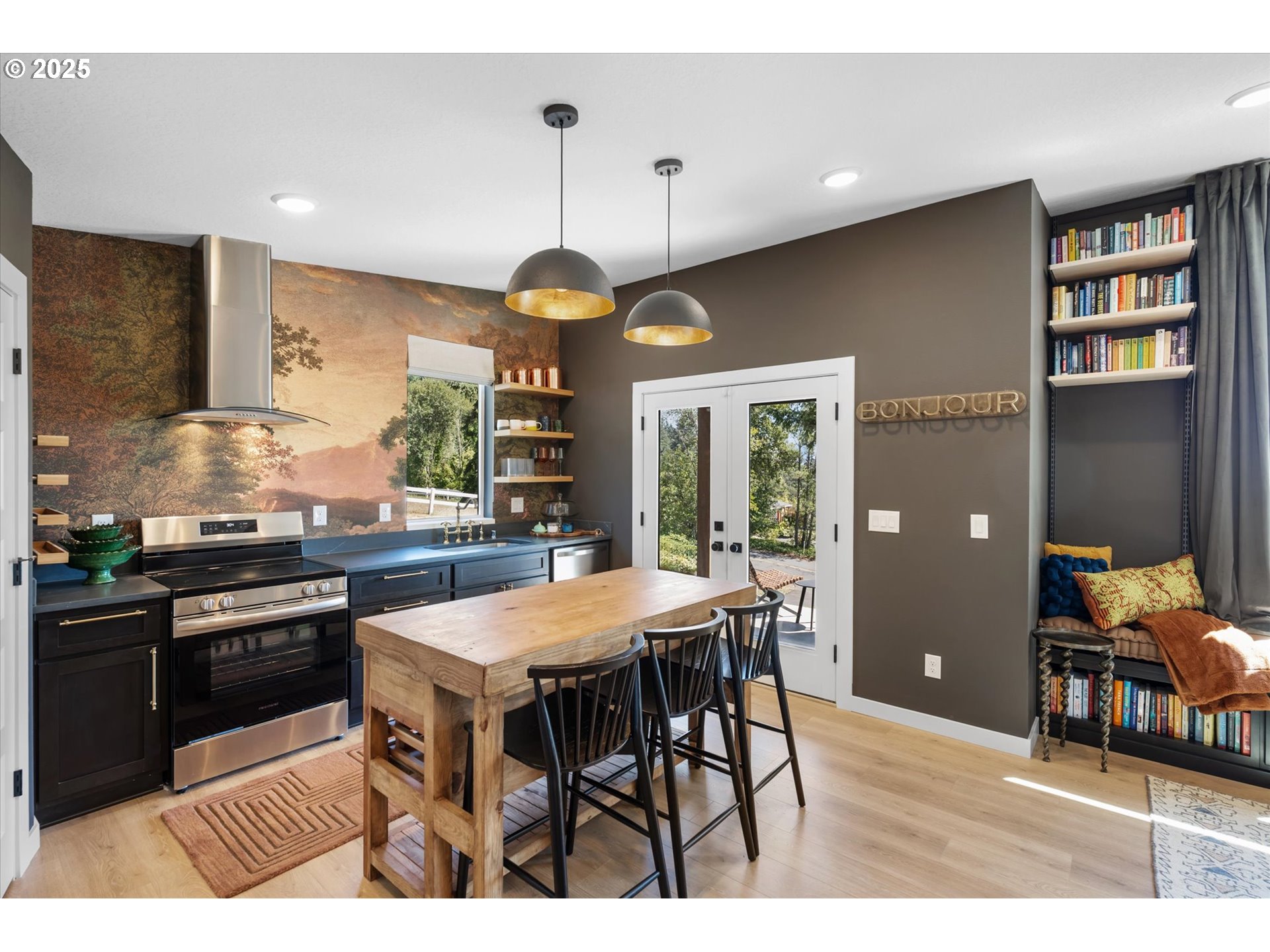 810 Taylor Road Kalama, WA 98625 - Photo 4 of 35 a kitchen with stainless steel appliances granite countertop a stove top oven a sink a dining table and chairs with wooden floor
