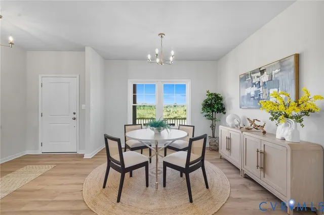 a kitchen with stainless steel appliances granite countertop a stove top oven a sink dishwasher and white cabinets with wooden floor