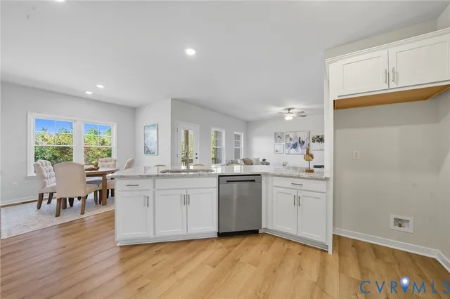 a kitchen with stainless steel appliances granite countertop a stove a sink a dining table and chairs