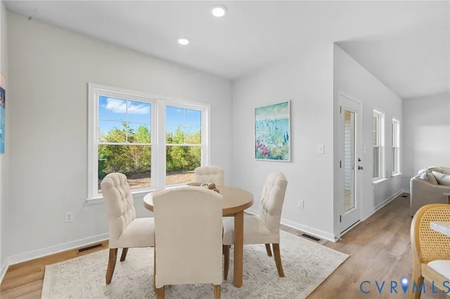 an empty room with wooden floor ceiling fan with window