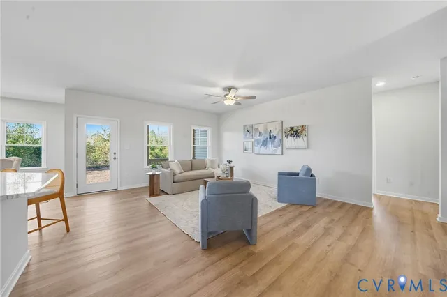 a living room with furniture kitchen and a table