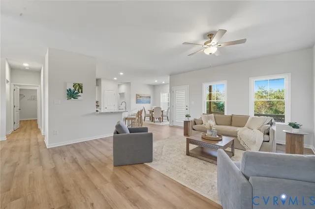 a living room with furniture and a wooden floor