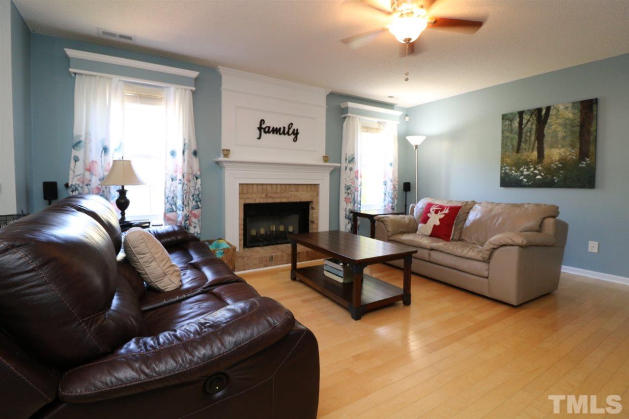 4517 Drewbridge Way Raleigh, NC 27604 - Photo 11 of 30 a living room with furniture and a fireplace