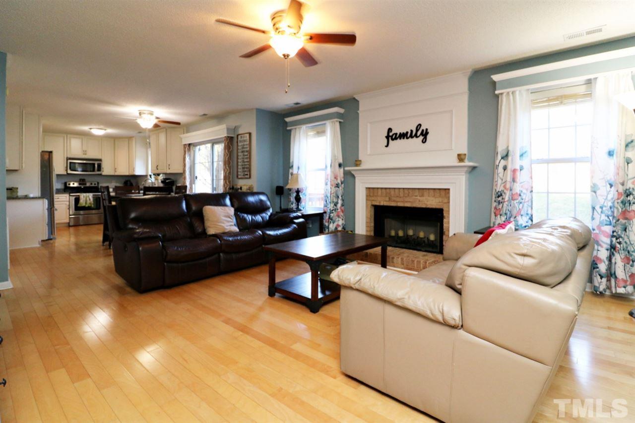 4517 Drewbridge Way Raleigh, NC 27604 - Photo 12 of 30 a living room with furniture and a fireplace