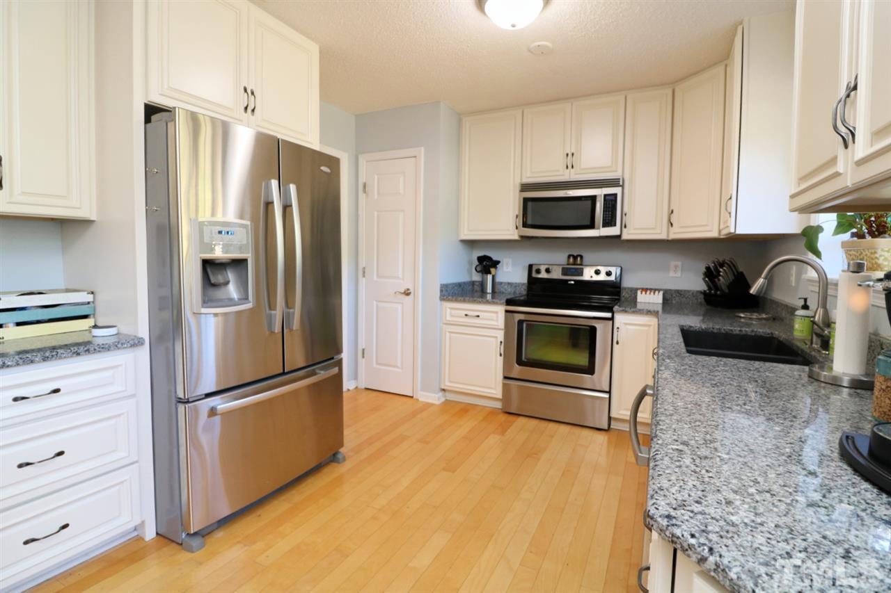 4517 Drewbridge Way Raleigh, NC 27604 - Photo 15 of 30 a kitchen with stainless steel appliances granite countertop a refrigerator stove and microwave