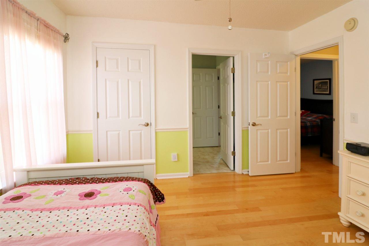 4517 Drewbridge Way Raleigh, NC 27604 - Photo 21 of 30 a bedroom with a bed and a dresser