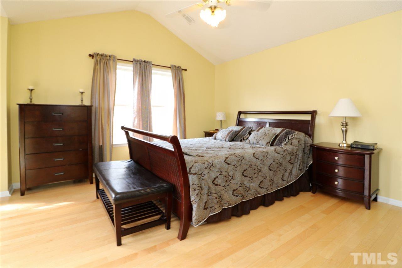 4517 Drewbridge Way Raleigh, NC 27604 - Photo 22 of 30 a bedroom with a bed and a dresser
