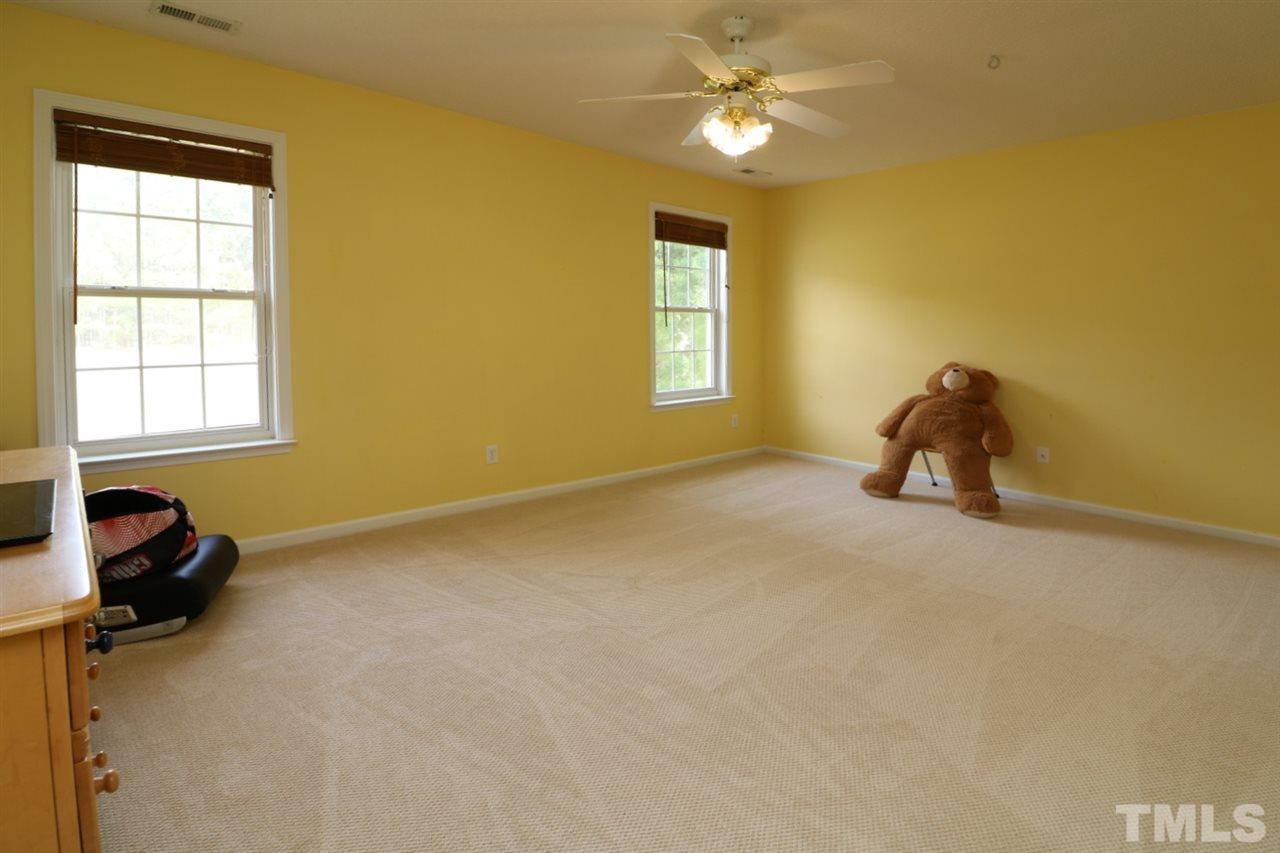 4517 Drewbridge Way Raleigh, NC 27604 - Photo 25 of 30 a bedroom with a bed and a window