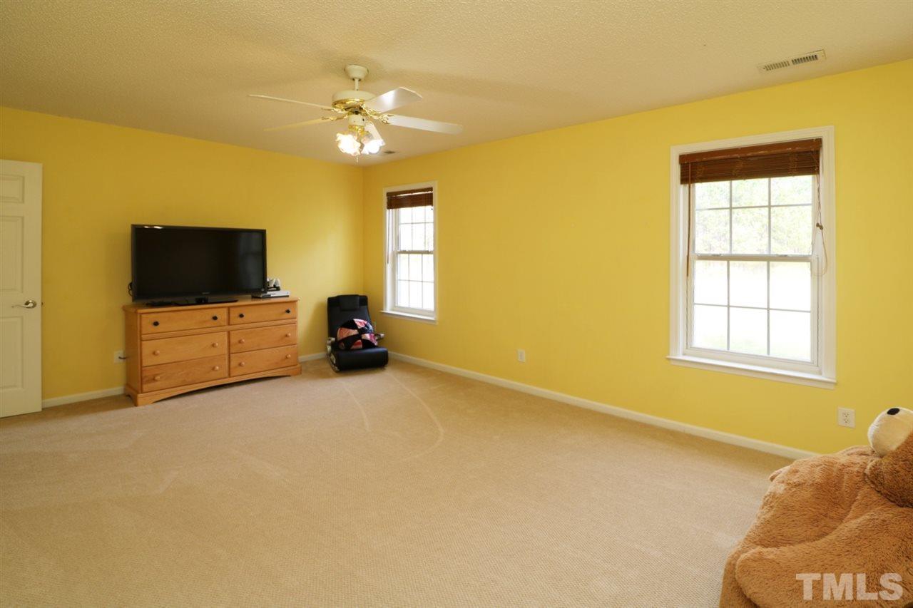 4517 Drewbridge Way Raleigh, NC 27604 - Photo 26 of 30 a living room with furniture and a flat screen tv