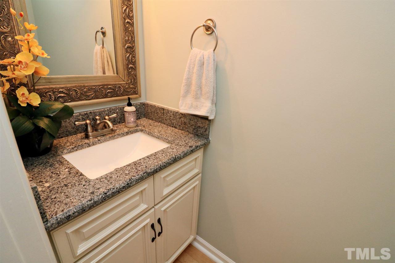 4517 Drewbridge Way Raleigh, NC 27604 - Photo 9 of 30 a bathroom with a granite countertop sink and a mirror