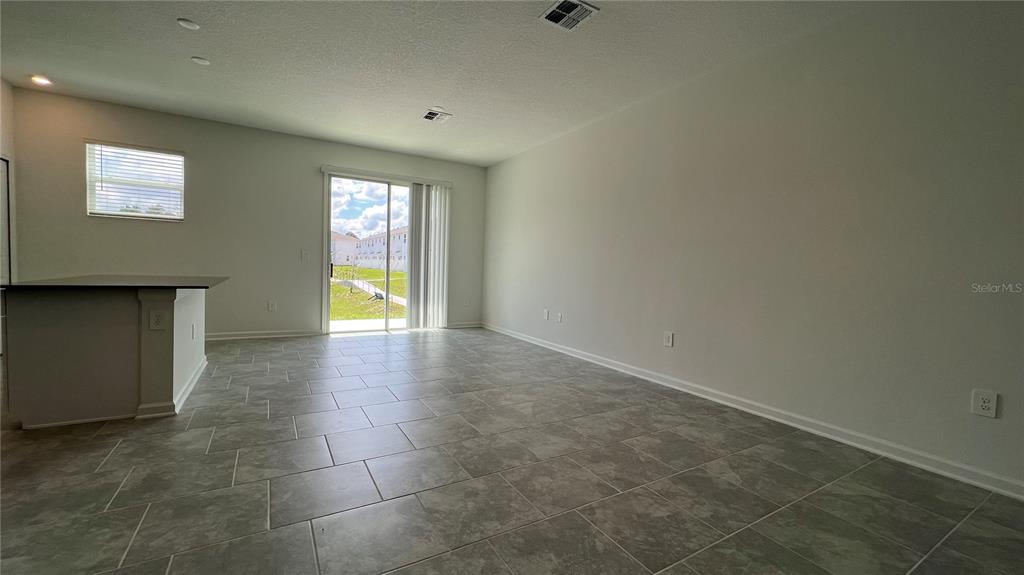 2396 Brook Marsh Loop Kissimmee, FL 34747 - Photo 13 of 29 a view of an empty room with glass door
