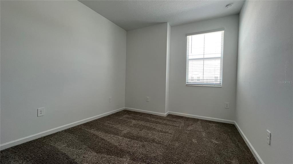 2396 Brook Marsh Loop Kissimmee, FL 34747 - Photo 16 of 29 an empty room with a window