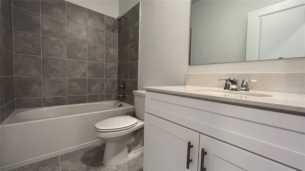 2396 Brook Marsh Loop Kissimmee, FL 34747 - Photo 22 of 29 a bathroom with a sink a toilet and a bathtub