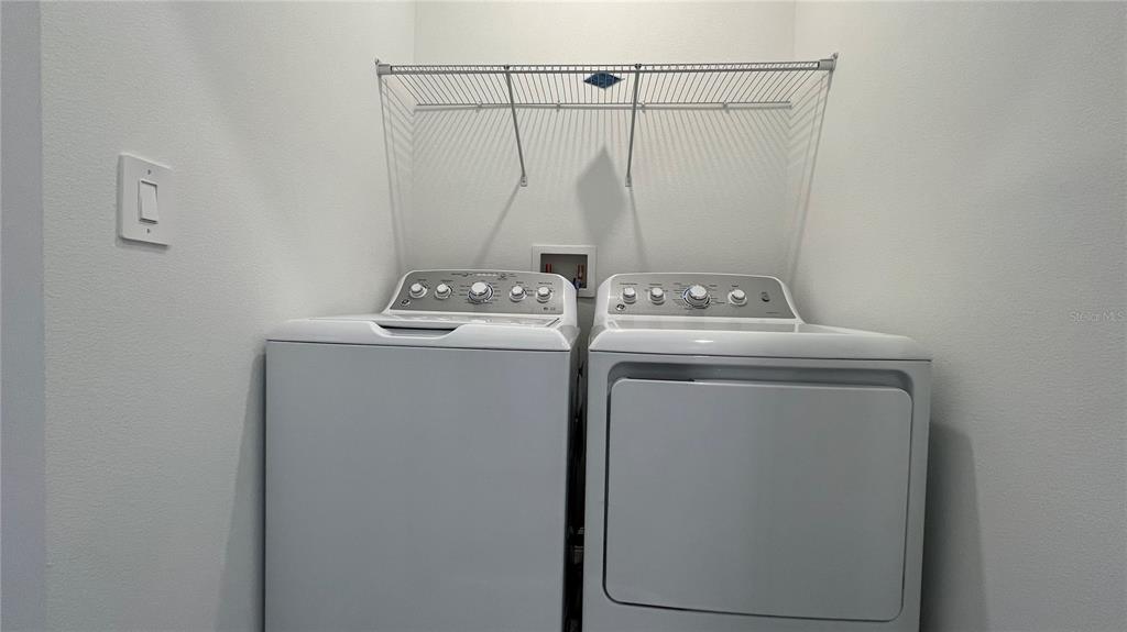 2396 Brook Marsh Loop Kissimmee, FL 34747 - Photo 23 of 29 a utility room with dryer and washer