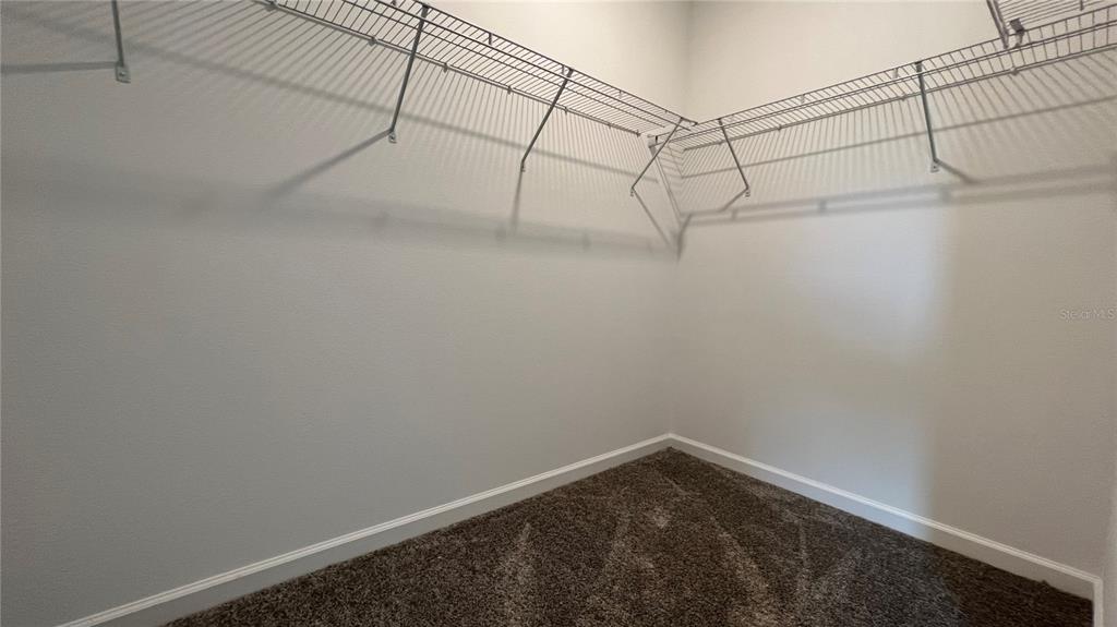 2396 Brook Marsh Loop Kissimmee, FL 34747 - Photo 27 of 29 a view of a room with racks on the wall