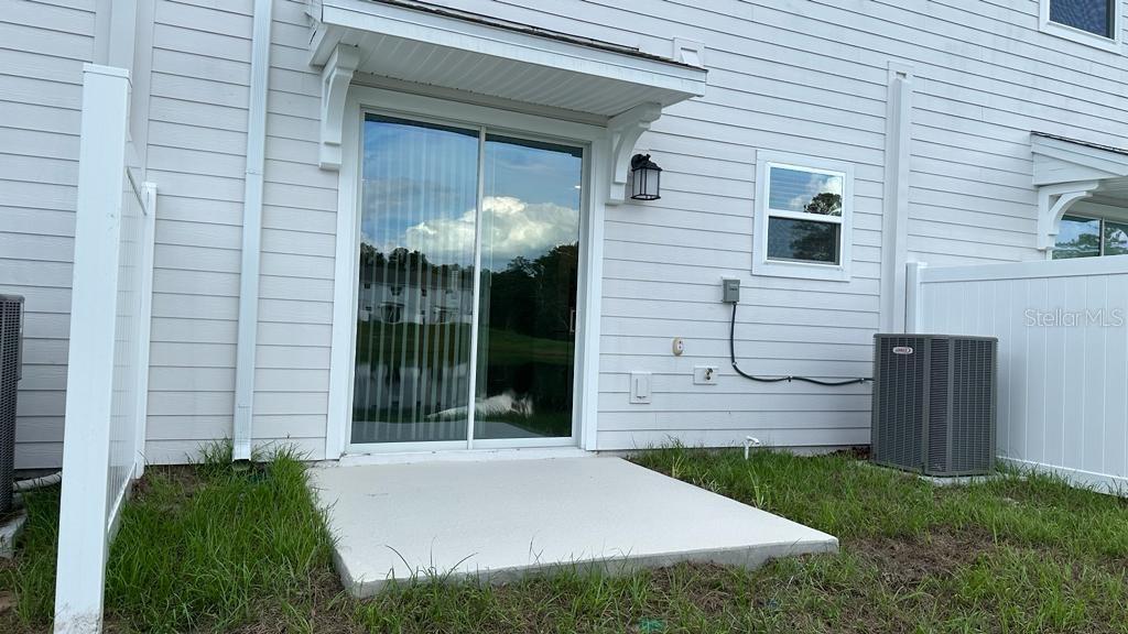 2396 Brook Marsh Loop Kissimmee, FL 34747 - Photo 28 of 29 a view of a house with a small backyard