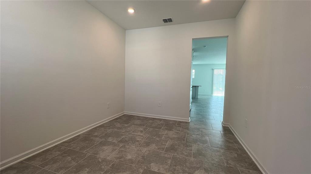2396 Brook Marsh Loop Kissimmee, FL 34747 - Photo 4 of 29 wooden floor in an empty room