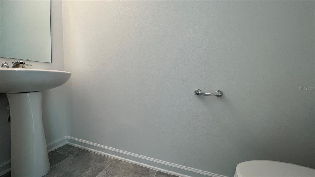 2396 Brook Marsh Loop Kissimmee, FL 34747 - Photo 7 of 29 a bathroom with a sink and a toilet