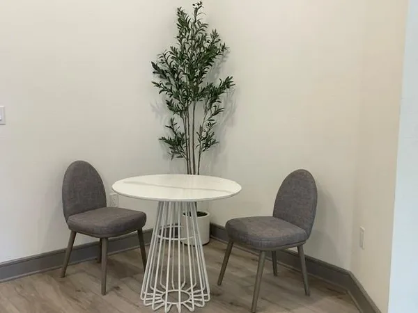 a view of a livingroom with furniture and a potted plant