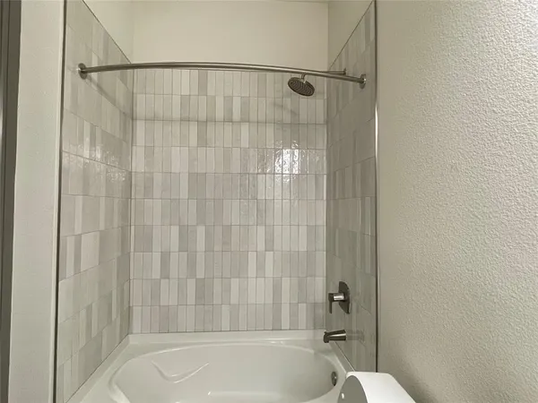 a bathroom with a shower and a bathtub