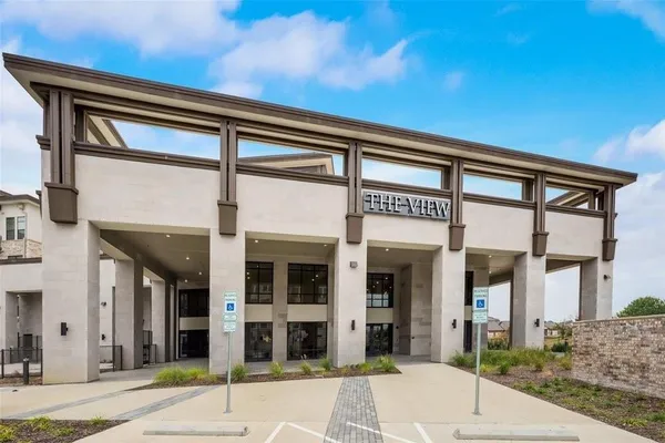 a front view of a building with a yard