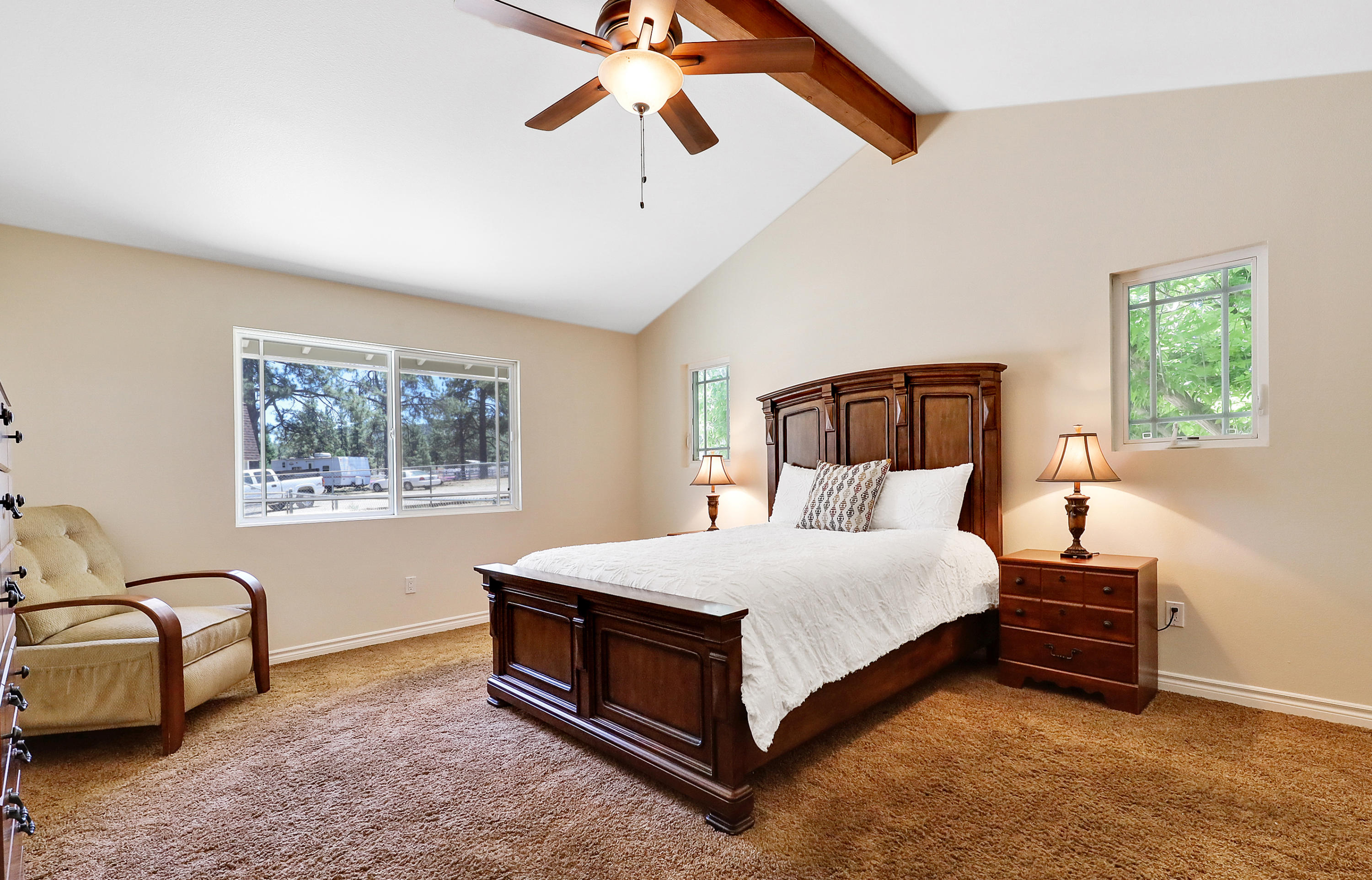 36211 Tool Box Spring Road Mountain Center, CA 92561 - Photo 17 of 26 a spacious bedroom with a bed a couch and a window