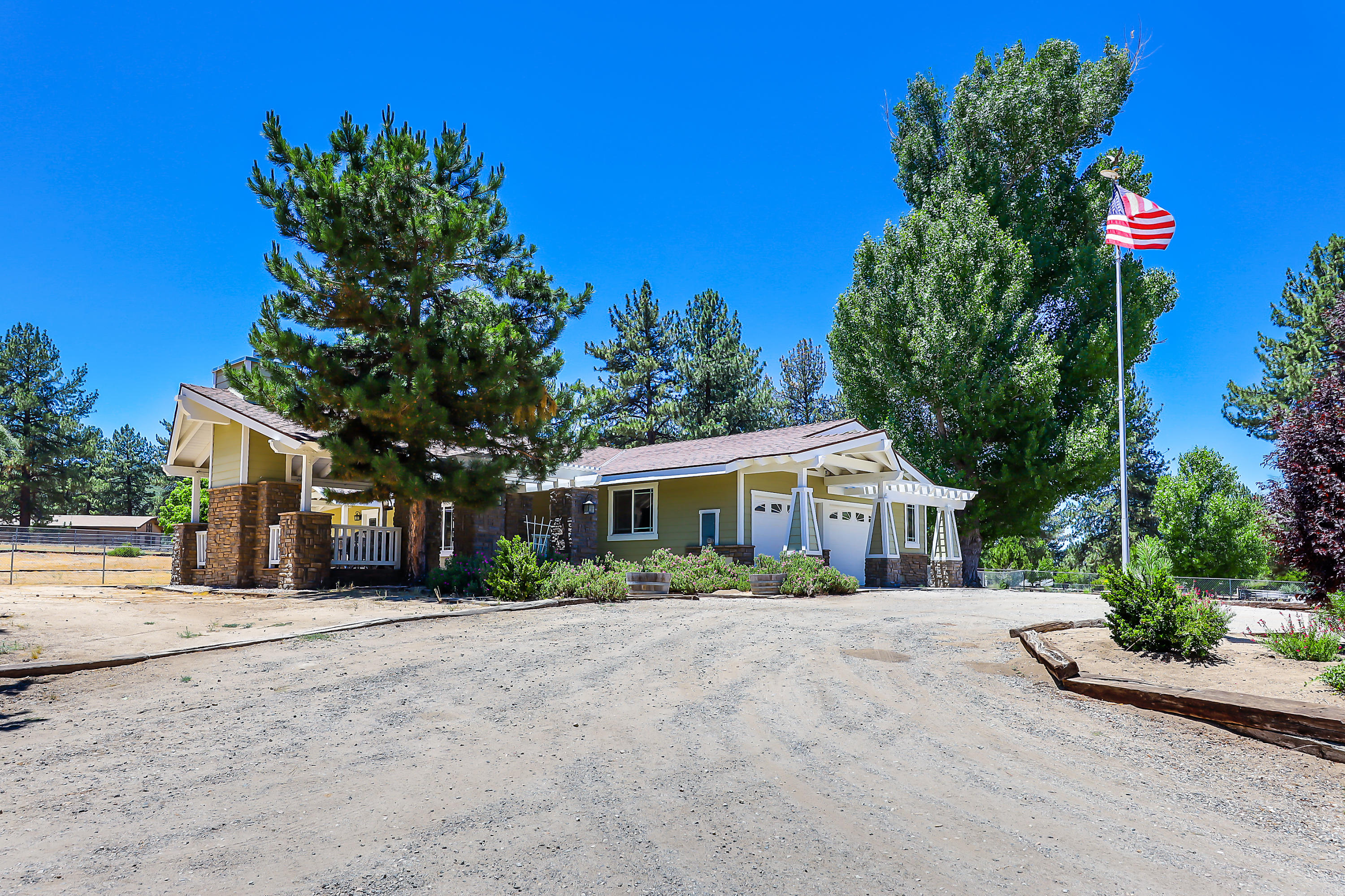 36211 Tool Box Spring Road Mountain Center, CA 92561 - Photo 20 of 26 a front view of a house with a yard and potted plants