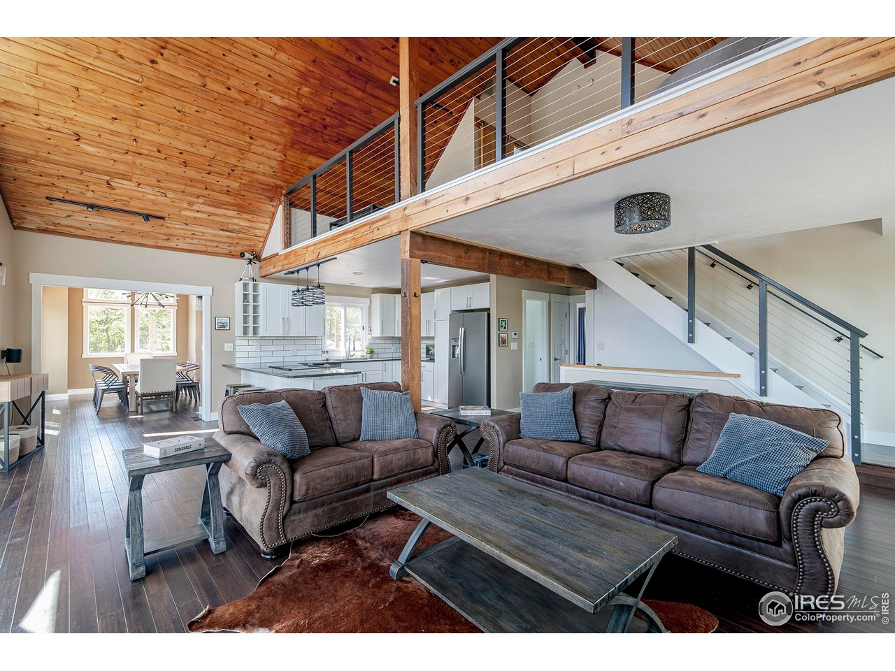 61 County Road 8501 Tabernash, CO 80478 - Photo 9 of 38 Living area with vaulted ceilings with tongue and groove wood, gas fireplace and wood floors Public