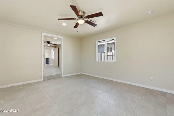 an empty room with closet and windows
