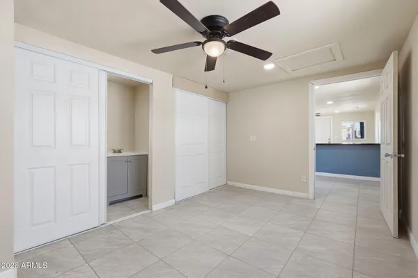 a view of an empty room and kitchen