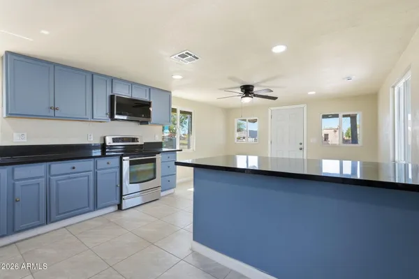 a kitchen with sink a microwave and cabinets