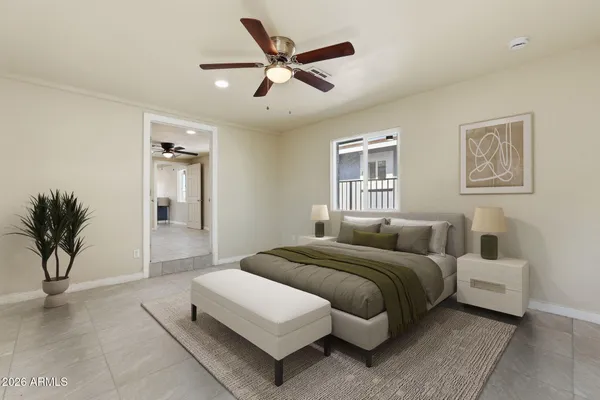 a bedroom with a bed and a potted plant