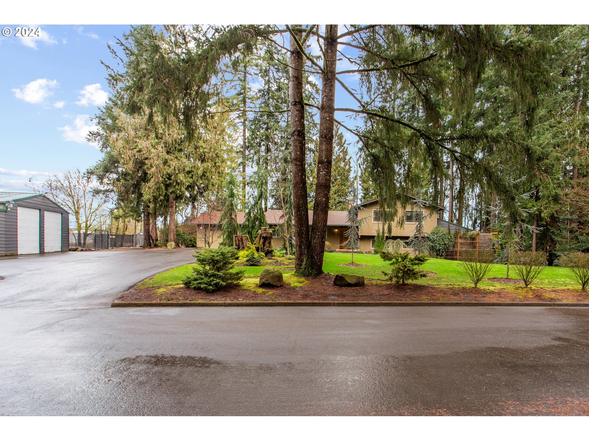 3308 Northwest 203rd Street Ridgefield, WA 98642 - Photo 3 of 41 a front view of a house with a yard and green space