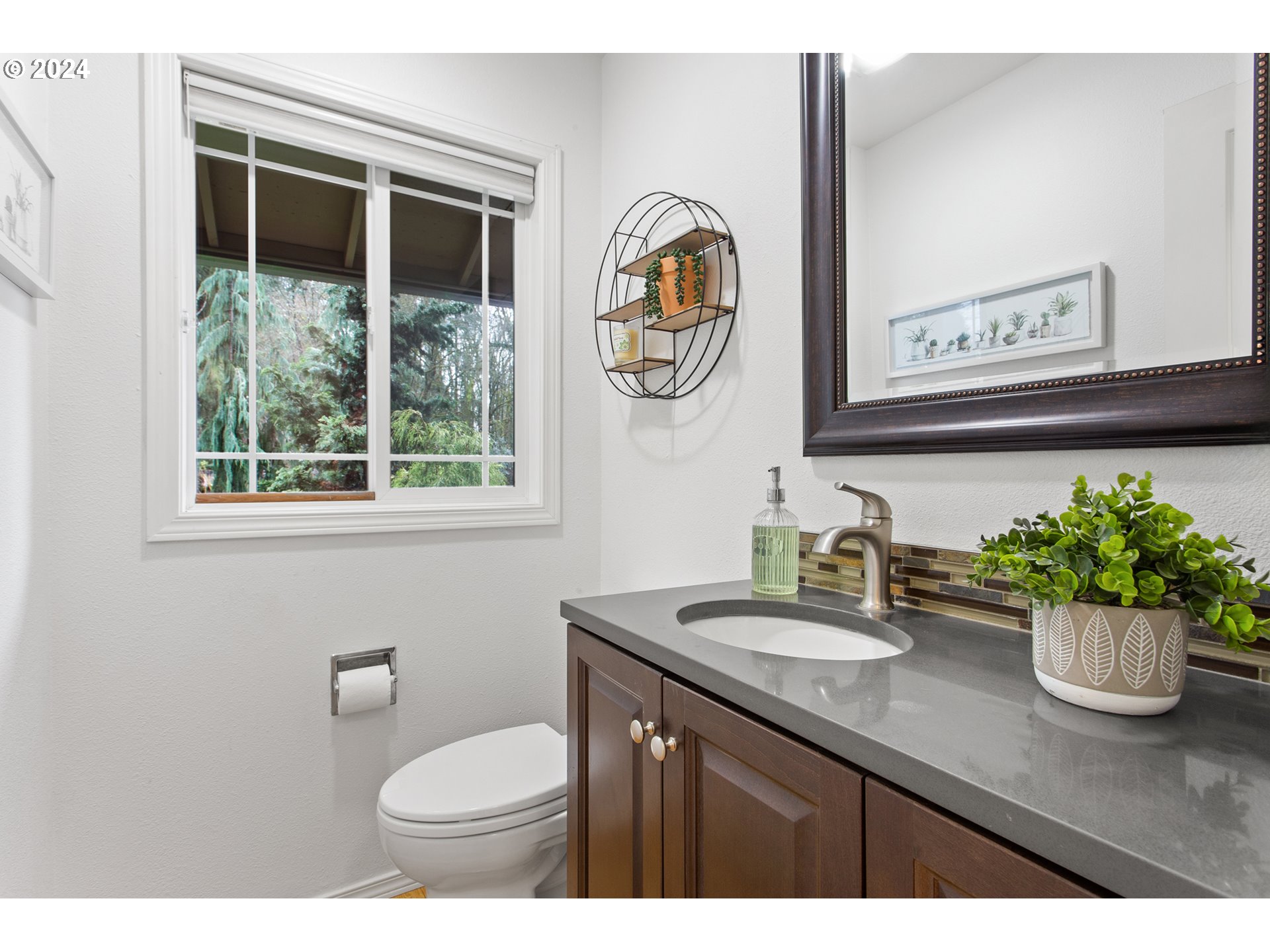 3308 Northwest 203rd Street Ridgefield, WA 98642 - Photo 35 of 41 a bathroom with a toilet a sink and mirror