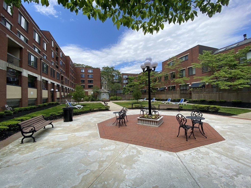 85 Brainerd Road, Unit 510 Boston, MA 02134 - Photo 20 of 25 a view of a patio with a table and chairs