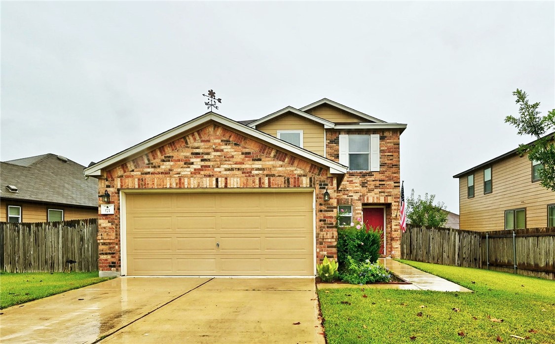 a view of front of house with a yard