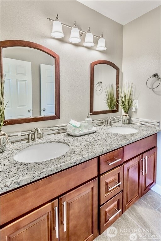 2241 South 252nd Street Des Moines, WA 98198 - Photo 11 of 25 a bathroom with a granite countertop sink and a mirror