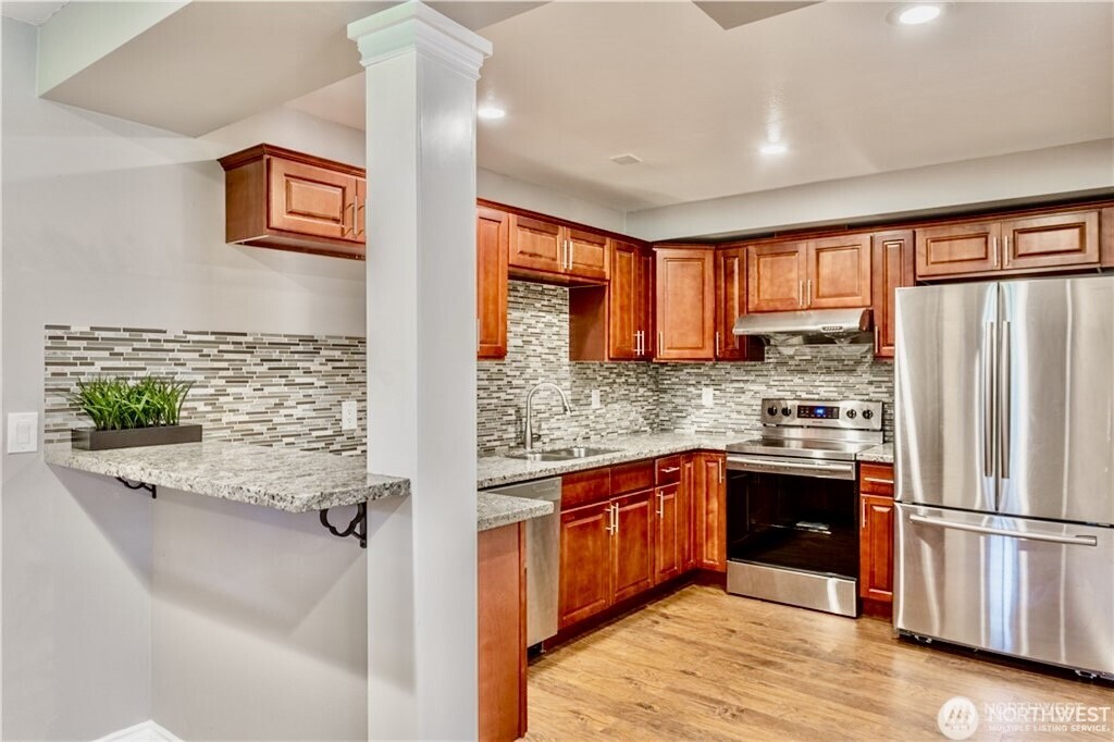 2241 South 252nd Street Des Moines, WA 98198 - Photo 15 of 25 a kitchen with stainless steel appliances granite countertop a refrigerator and a sink