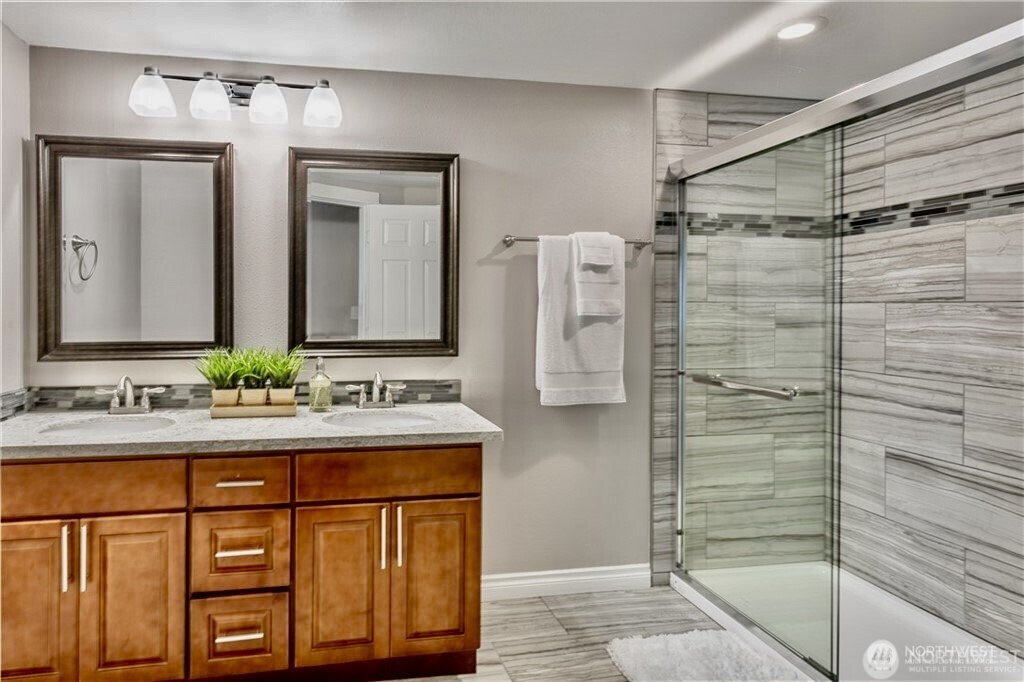 2241 South 252nd Street Des Moines, WA 98198 - Photo 17 of 25 a bathroom with a granite countertop sink a mirror and shower