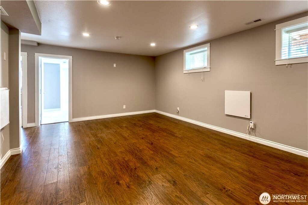 2241 South 252nd Street Des Moines, WA 98198 - Photo 20 of 25 an empty room with wooden floor and windows