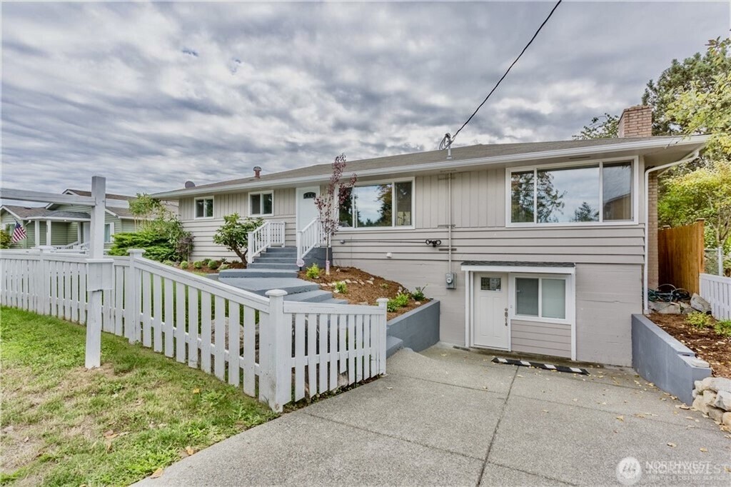 2241 South 252nd Street Des Moines, WA 98198 - Photo 2 of 25 a view of a house with wooden fence and a porch