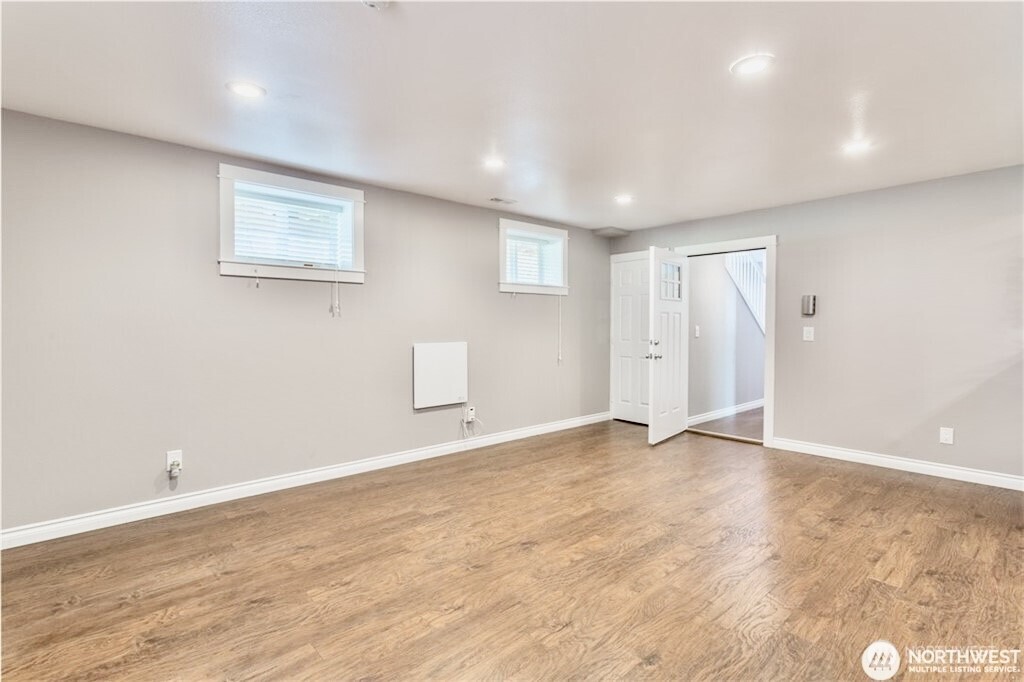 2241 South 252nd Street Des Moines, WA 98198 - Photo 21 of 25 an empty room with wooden floor and windows