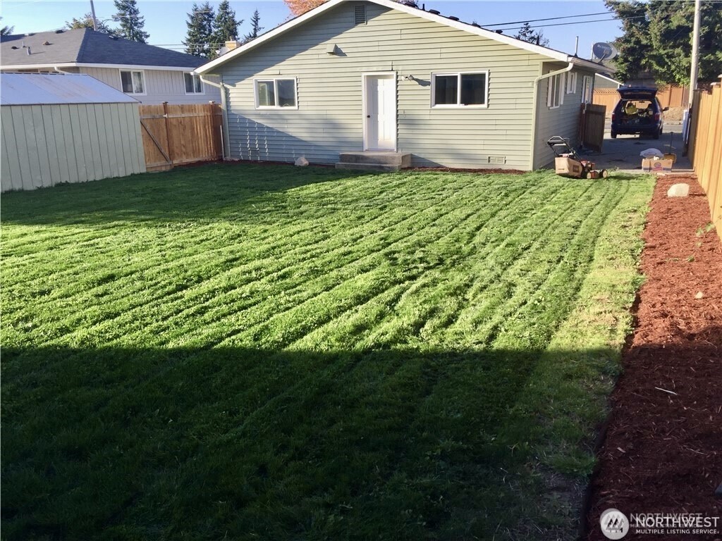 2241 South 252nd Street Des Moines, WA 98198 - Photo 22 of 25 a view of a backyard with a garden