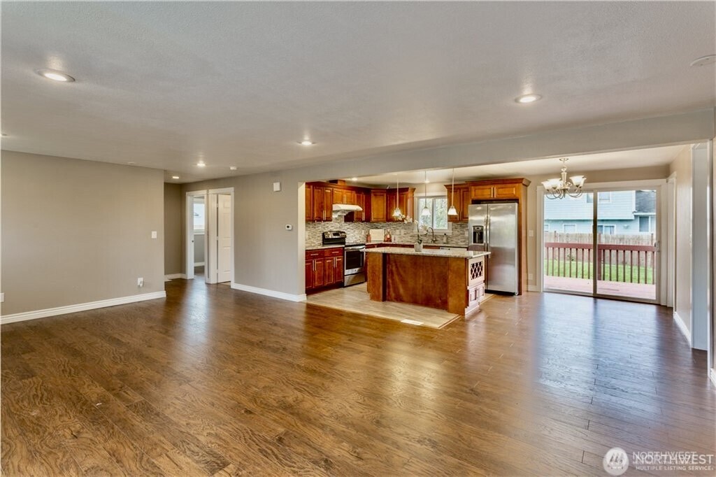 2241 South 252nd Street Des Moines, WA 98198 - Photo 9 of 25 a view of kitchen with kitchen island and stainless steel appliances with wooden floor