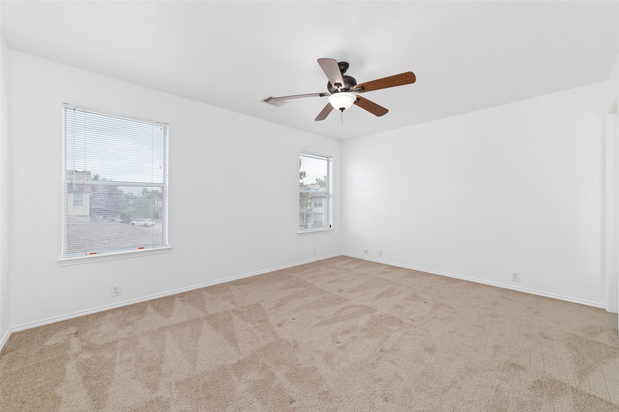 23602 Youpon Lake Lane Spring, TX 77373 - Photo 12 of 21 Spacious primary bedroom with ceiling fan and natural light.